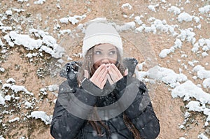 Beautiful young woman outside while its snowing