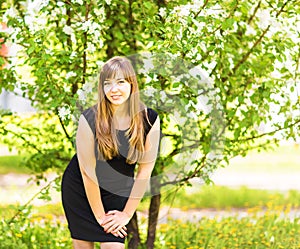 Beautiful young woman over white blossom tree, outdoors spring portrait