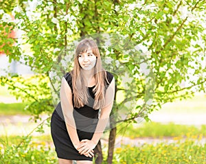 Beautiful young woman over white blossom tree, outdoors spring portrait