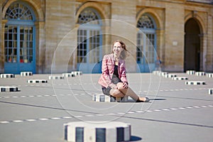 Beautiful young woman in Palais Royale in Paris