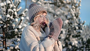 Beautiful young woman in park in Christmas vacation, portrait of pretty girl in warm clothing