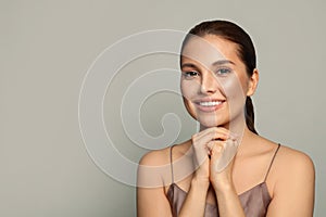 Beautiful Young Woman with Perfect Skin Touching her Face. Facial treatment, cosmetology, beauty and spa concept