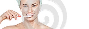 Beautiful young woman with perfect smile brushing her teeth over white background studio shot. Teeth whitening concept banner.
