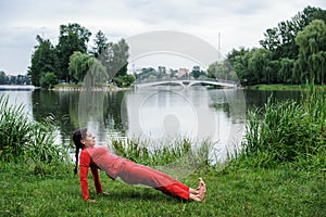 Beautiful young woman performing yoga exercises