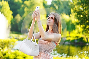 Beautiful young woman photographed on a mobile phone