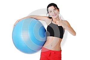 Beautiful young woman with pilates exercise ball.
