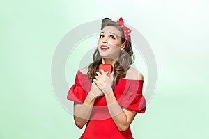 Beautiful young woman with pinup make-up and hairstyle. Studio shot on white background