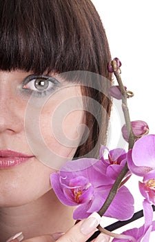 Beautiful young woman with pink flower