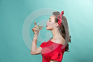 Beautiful young woman with pinup make-up and hairstyle. Studio shot on white background