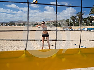 Beautiful young woman playing beachvolleyball