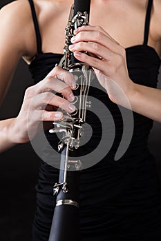 Beautiful young woman playing clarinet