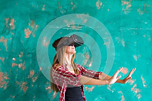 Beautiful young woman playing game in virtual reality glasses