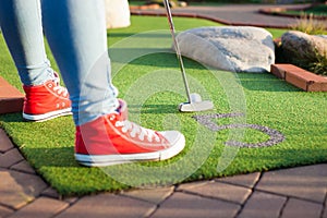 Beautiful young woman playing golf