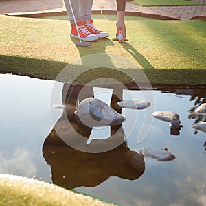 Beautiful young woman playing golf