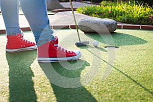 Beautiful young woman playing golf