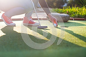 Beautiful young woman playing golf