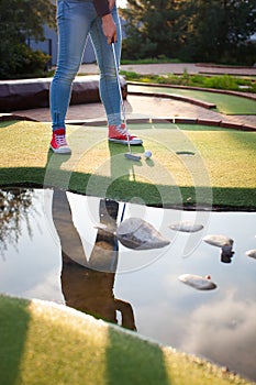 Beautiful young woman playing golf