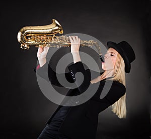 Beautiful young woman playing saxophone
