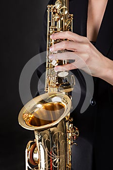 Beautiful young woman playing saxophone