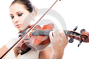 Beautiful young woman playing violin over white