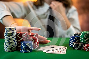 beautiful young woman poker player discards playing cards by throwing them on the table.