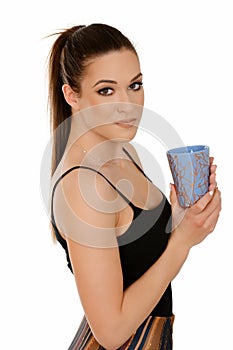 Beautiful young woman with pony tail holding cup