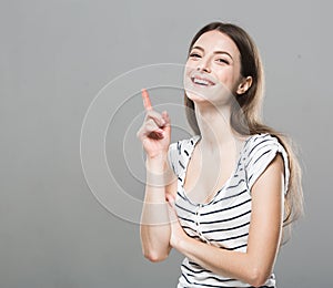 Beautiful young woman portrait cute tender pure smiling posing gray background