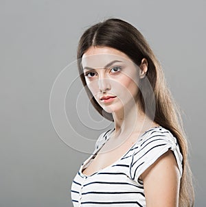 Beautiful young woman portrait cute tender pure smiling posing gray background