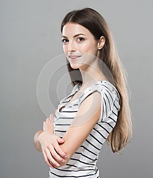 Beautiful young woman portrait cute tender pure smiling posing gray background