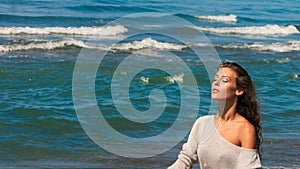 Beautiful young woman portrait enjoy in sun and sea air on beach closed eyes relaxing summer