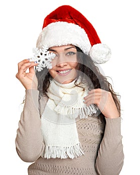 Beautiful young woman portrait in santa helper hat with big snowflake posing on white