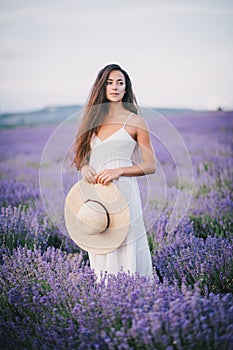 Beautiful young woman posing in a lavender field