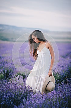 Beautiful young woman posing in a lavender field