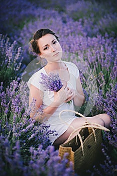 Beautiful young woman posing in a lavender field