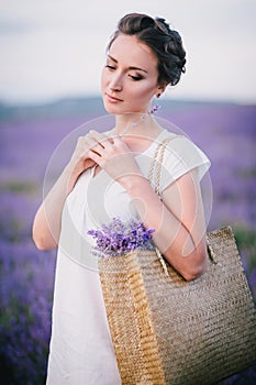 Beautiful young woman posing in a lavender field