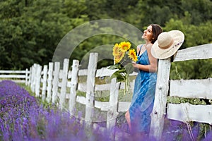 Beautiful young woman posing in lavender field