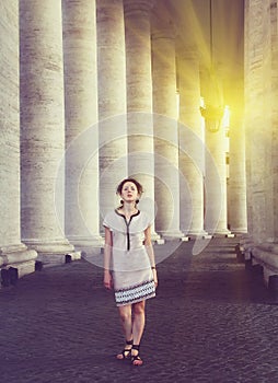 A beautiful young woman posing near St. Peter's square in Vatican, Rome