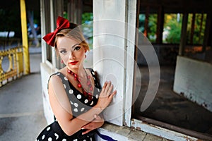 Beautiful young woman posing in retro dress