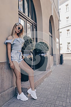 Beautiful young woman posing in the street, wearing shorts Fashion summer photo photo