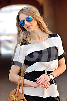 Beautiful young woman posing in sunglasses