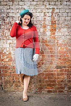 Beautiful young woman posing in vintage 1940s clothes