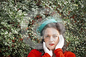 Beautiful young woman posing in vintage 1940s clothes