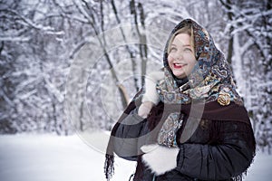 Beautiful young woman posing in winter park, plus size model on a snowy background