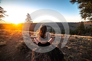 Beautiful young woman practice yoga at sunset time on nature outdoors. Healthy lifestyle concept