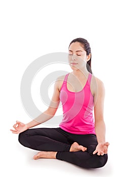 Beautiful young woman practicing yoga, sitting in a lotus position, isolated on white