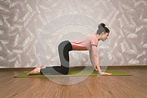 Woman practising yoga,home workout concept