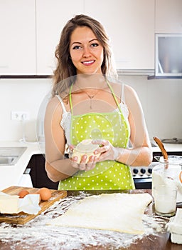 Beautiful young woman preparing cakes