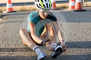 Beautiful young woman preparing for cycling on road. photo
