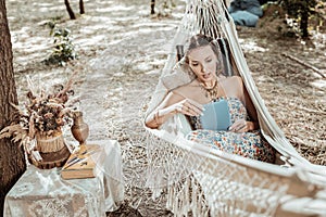 Beautiful young woman reading something in tablet