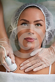 Beautiful young woman receiving cavitation treatment skin